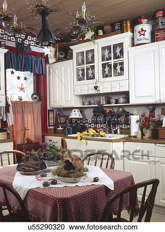 Stock Image - Dining table in small country kitchen. Fotosearch