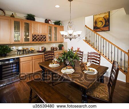 Dining Table With Bench And Ladder Back Chairs Stock Image