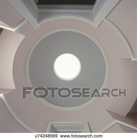 Stock Photo - Directly below shot of ceiling with circular skylight at entrance. Fotosearch