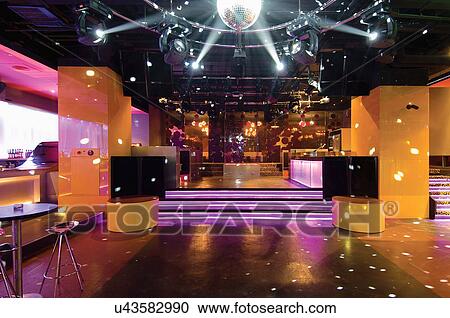 Stock Image - Disco ball over dance floor in nightclub. Fotosearch