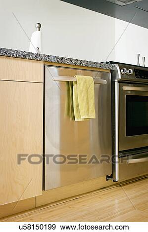 Dish towel hanging on dishwasher in kitchen View Large Photo Image Stock Photo - Dish towel hanging on dishwasher in kitchen. Fotosearch