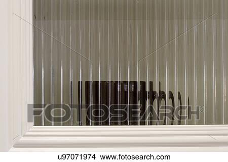 Distorted coffee mug behind glass cabinet; Aliso Viejo; California; USA View Large Photo Image Picture - Distorted coffee mug behind glass cabinet; Aliso Viejo; California; USA. Fotosearch