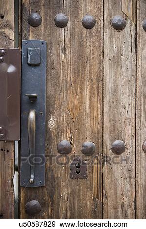 Stock Photo - Doorknob and keyhole of old wooden door; Hollywood; California; USA. Fotosearch
