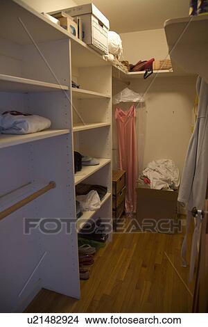 Dress hanging in large empty closet; Carpinteria; California; USA View Large Photo Image Picture - Dress hanging in large empty closet; Carpinteria; California; USA. Fotosearch