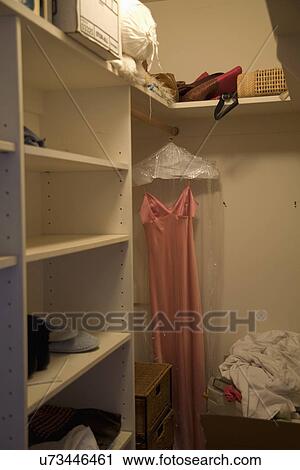 Dress hanging in large empty closet; Carpinteria; California; USA View Large Photo Image Stock Image - Dress hanging in large empty closet; Carpinteria; California; USA. Fotosearch