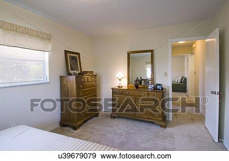 Stock Photo - Dressers in master bedroom of a traditional home. Fotosearch
