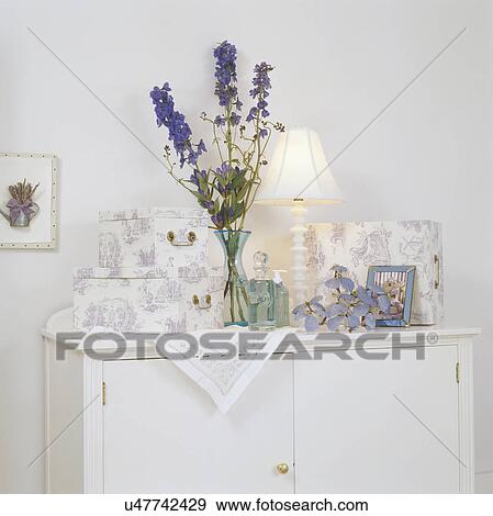Stock Photo - Dressing cases, lamp and flower vase on top of dresser. Fotosearch