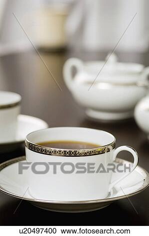 Stock Image - Elegant coffee cup on saucer. Fotosearch
