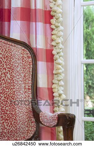 Stock Image - Empty armchair by window. Fotosearch