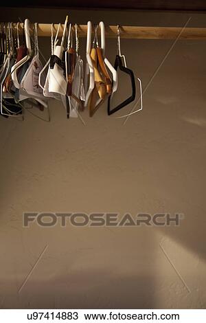 Empty hangers hanging on wooden rod; Porterville; California; USA View Large Photo Image Stock Image - Empty hangers hanging on wooden rod; Porterville; California; USA. Fotosearch