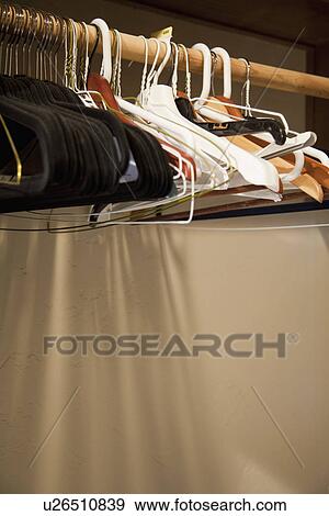 Empty hangers hanging on wooden rod; Porterville; California; USA View Large Photo Image Stock Photo - Empty hangers hanging on wooden rod; Porterville; California; USA. Fotosearch