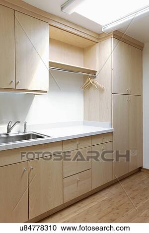 Stock Image - Empty laundry room in contemporary home. Fotosearch