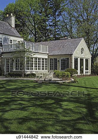EXTERIOR - Backyard of house, shingle roof, large yard, stone patio. View Large Photo Image Stock Image - EXTERIOR - Backyard of house, shingle roof, large yard, stone patio. . Fotosearch