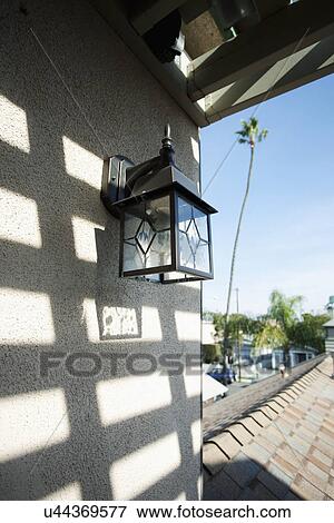 Stock Photo - Exterior light mounted on wall; Seal Beach; California; USA. Fotosearch