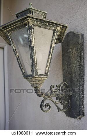 Stock Image - Exterior light mounted on wall; Trabuco Canyon; California; USA. Fotosearch
