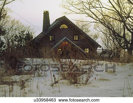 EXTERIOR: Log home in snow, twilight, trees, dried grasses View Large Photo Image Stock Image - EXTERIOR: Log home in snow, twilight, trees, dried grasses . Fotosearch