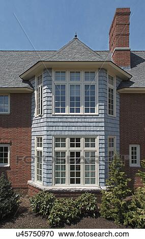Stock Image - Exterior of a single family home with casemate windows. Fotosearch