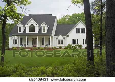 Stock Image - Exterior of a single family home with lawn in yard. Fotosearch