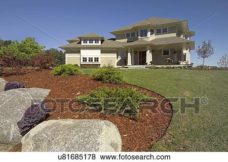 Stock Photo - Exterior of a single family home with lawn in front. Fotosearch