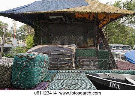 Picture - Exterior of cottage covered with fishing nets. Fotosearch