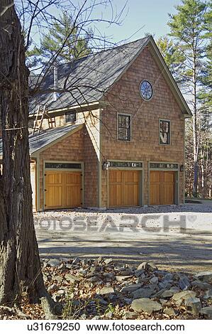Exterior of single family home with wooden doors at garage View Large Photo Image Stock Image - Exterior of single family home with wooden doors at garage. Fotosearch