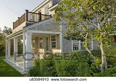 Stock Image - Exterior of single family home with plants. Fotosearch