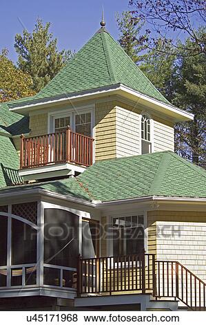 Stock Photo - Exterior of single family home with shingled roof and staircase. Fotosearch