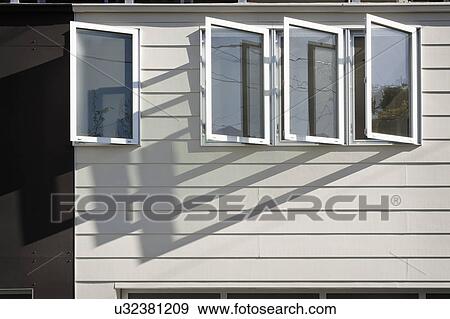 Stock Photo - Exterior view of open casement windows on home. Fotosearch