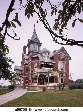 Picture - Exterior view Southern brick Queen Anne Victorian home; Flag City; Ohio; USA. Fotosearch