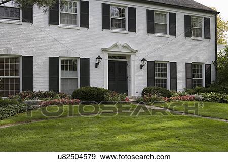 Stock Photograph Of Exterior White Brick Traditional Colonial Home Exterior White Brick Traditional Colonial Home With Black Shutters Pediment Above The Door