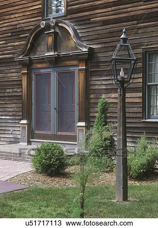 EXTERIORS: a replica of the Parson Ashley House, circa 1733, purposely weathered front entrance, pediment, double doors, lantern to right View Large Photo Image Stock Image - EXTERIORS: a replica of the Parson Ashley House, circa 1733, purposely weathered front entrance, pediment, double doors, lantern to right. Fotosearch
