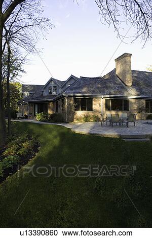 EXTERIORS: brick ranch home, back yard with patio area, vertical View Large Photo Image Stock Image - EXTERIORS: brick ranch home, back yard with patio area, vertical. Fotosearch