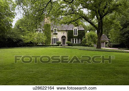 EXTERIORS: Ivy covered French Normandy style home, straight on view horizontal, sweeping lawn View Large Photo Image Picture - EXTERIORS: Ivy covered French Normandy style home, straight on view horizontal, sweeping lawn. Fotosearch