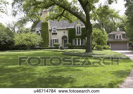 EXTERIORS: Ivy covered French Normandy style home, angled view with garage to right partial driveway shows, horizontal View Large Photo Image Picture - EXTERIORS: Ivy covered French Normandy style home, angled view with garage to right partial driveway shows, horizontal. Fotosearch