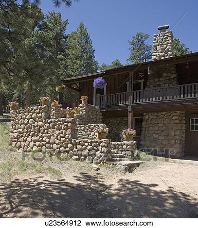 EXTERIORS: summer vacation home, fieldstone fireplace and stairway to cabin in Colorado potted flowers sit on ledges of stairway View Large Photo Image Stock Image - EXTERIORS: summer vacation home, fieldstone fireplace and stairway to cabin in Colorado potted flowers sit on ledges of stairway. Fotosearch