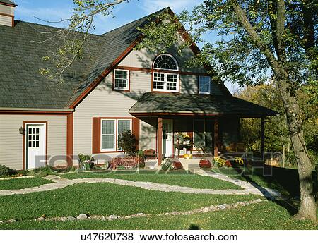 EXTERIORS: two story, country style, red trim, fall season with mums and pumpkins, porch swing, harsh sunlight, stone walkways View Large Photo Image Stock Photo - EXTERIORS: two story, country style, red trim, fall season with mums and pumpkins, porch swing, harsh sunlight, stone walkways. Fotosearch