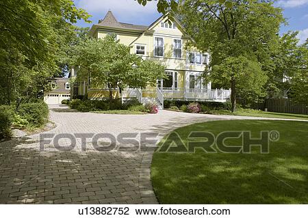 EXTERIORS: Yellow clapboard Victorian with white trim, curved cobblestone driveway, three story home, detached garage, surrounded by mature trees, porch/deck in front, horizontal version, sunny View Large Photo Image Stock Image - EXTERIORS: Yellow clapboard Victorian with white trim, curved cobblestone driveway, three story home, detached garage, surrounded by mature trees, porch/deck in front, horizontal version, sunny. Fotosearch