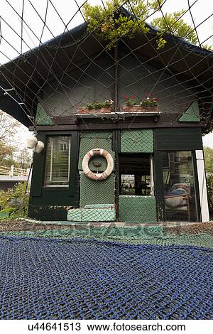 Facade of house covered in commercial fishing net View Large Photo Image Stock Image - Facade of house covered in commercial fishing net. Fotosearch