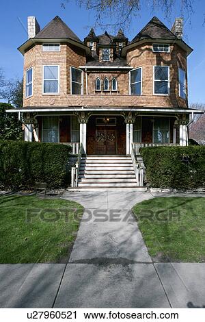Stock Image - Facade of residential house with lawn in foreground. Fotosearch