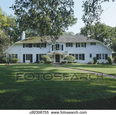 Facade of traditional white frame house with large lawn View Large Photo Image Stock Photography - Facade of traditional white frame house with large lawn. Fotosearch