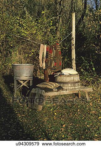 FALL SEASON: Antique wash tubs on bench, worn and weathered, clothes line, old quilts and vintage stockings hang on the line, View Large Photo Image Stock Photo - FALL SEASON: Antique wash tubs on bench, worn and weathered, clothes line, old quilts and vintage stockings hang on the line,. Fotosearch