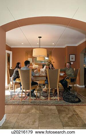 Family around dining table in contemporary home, Albuquerque, New Mexico, USA View Large Photo Image Stock Photo - Family around dining table in contemporary home, Albuquerque, New Mexico, USA. Fotosearch