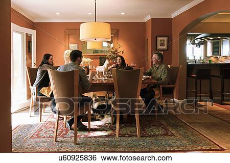 Stock Photograph - Family dining in luxuries dining room, Albuquerque, New Mexico, USA. Fotosearch