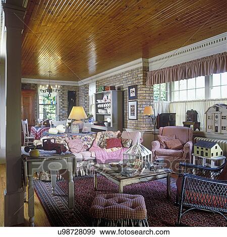 FAMILY ROOM - end of Great Room old house. Beadboard ceiling, dentil crown molding, cream city brick walls, ruffled valances, cafe curtains, cottage floral and ticking fabrics, vintage doll houses, styled with fall white pumpkins, and berries, columns sep View Large Photo Image Stock Photo - FAMILY ROOM - end of Great Room old house. Beadboard ceiling, dentil crown molding, cream city brick walls, ruffled valances, cafe curtains, cottage floral and ticking fabrics, vintage doll houses, styled with fall white pumpkins, and berries, columns sep. Fotosearch