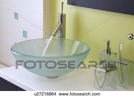 Picture - Faucet with running water in contemporary bowl sink; Lincoln; Nebraska; USA. Fotosearch