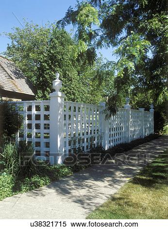 FENCES: Formal classical English style fence with lattice and posts are every 8ft with large urn like finials, ground cover, concrete sidewalk View Large Photo Image Stock Photography - FENCES: Formal classical English style fence with lattice and posts are every 8ft with large urn like finials, ground cover, concrete sidewalk. Fotosearch
