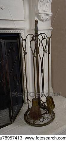 FIREPLACES: fireplace tool set, brown metal leaf design on a beige composite hearth View Large Photo Image Stock Image - FIREPLACES: fireplace tool set, brown metal leaf design on a beige composite hearth. Fotosearch