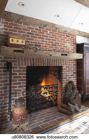 Firewood by metal grate in front of fireplace View Large Photo Image Stock Photograph - Firewood by metal grate in front of fireplace. Fotosearch