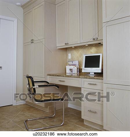 Flat screen monitor on stained wood cabinets with desk area surrounded by floor to ceiling, ceramic tile flooring and chair View Large Photo Image Stock Photograph - Flat screen monitor on stained wood cabinets with desk area surrounded by floor to ceiling, ceramic tile flooring and chair. Fotosearch