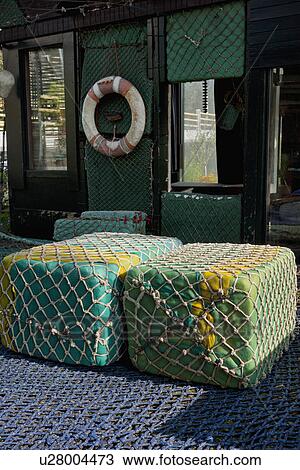 Floating buoys wrapped with commercial fishing nets in front of cottage View Large Photo Image Stock Image - Floating buoys wrapped with commercial fishing nets in front of cottage. Fotosearch